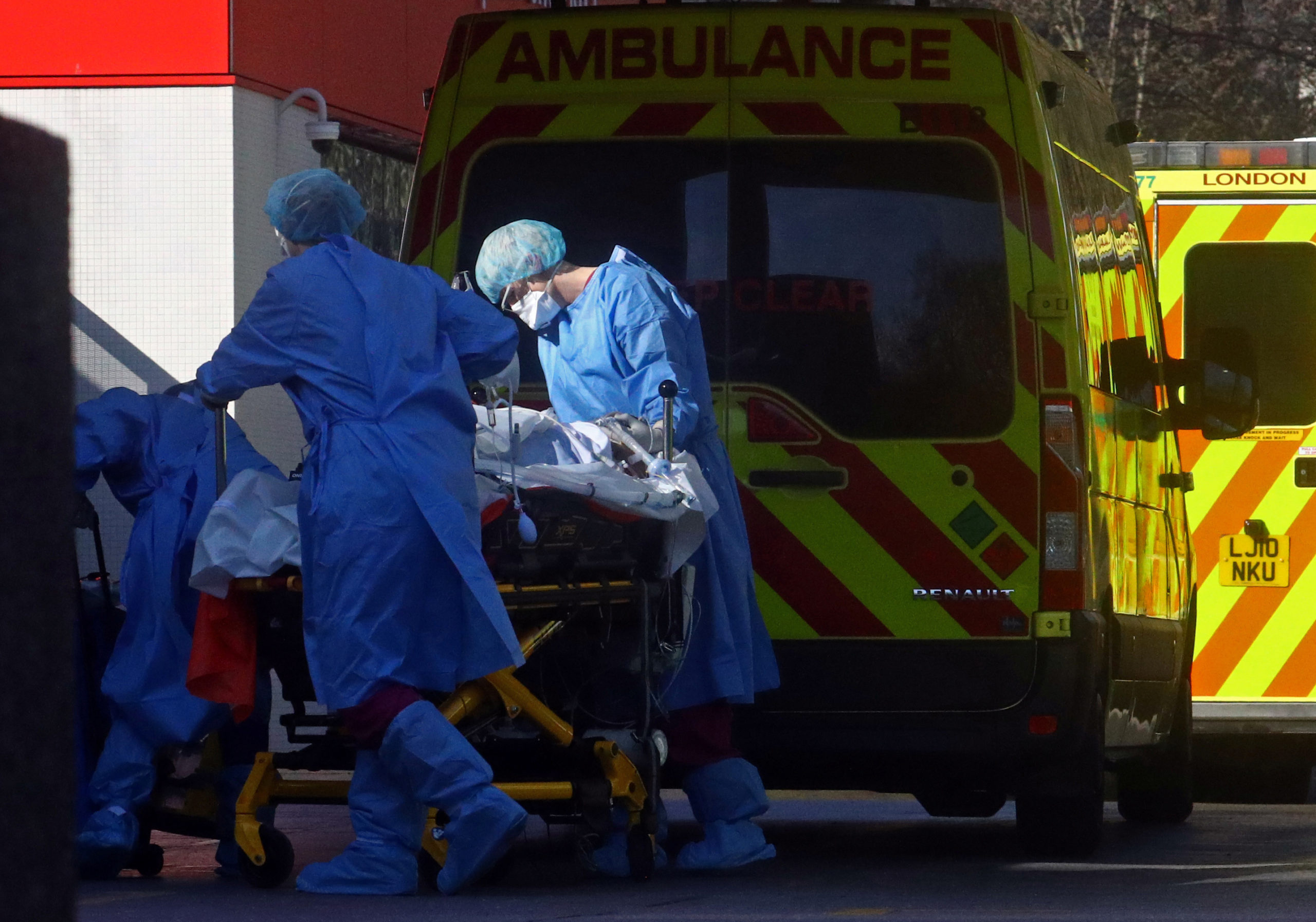 Medical staff with a patient at the back of an ambulance outside St Thomas's hospital as the spread of the coronavirus disease (COVID-19) continues in London