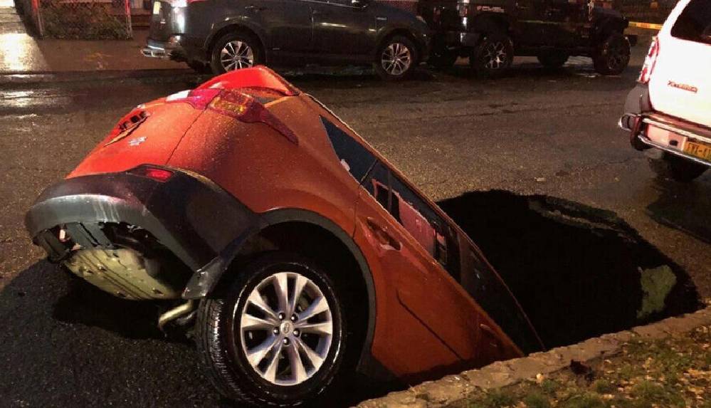 New York'taki yolda aniden açılan dev çukur, cipi yuttu