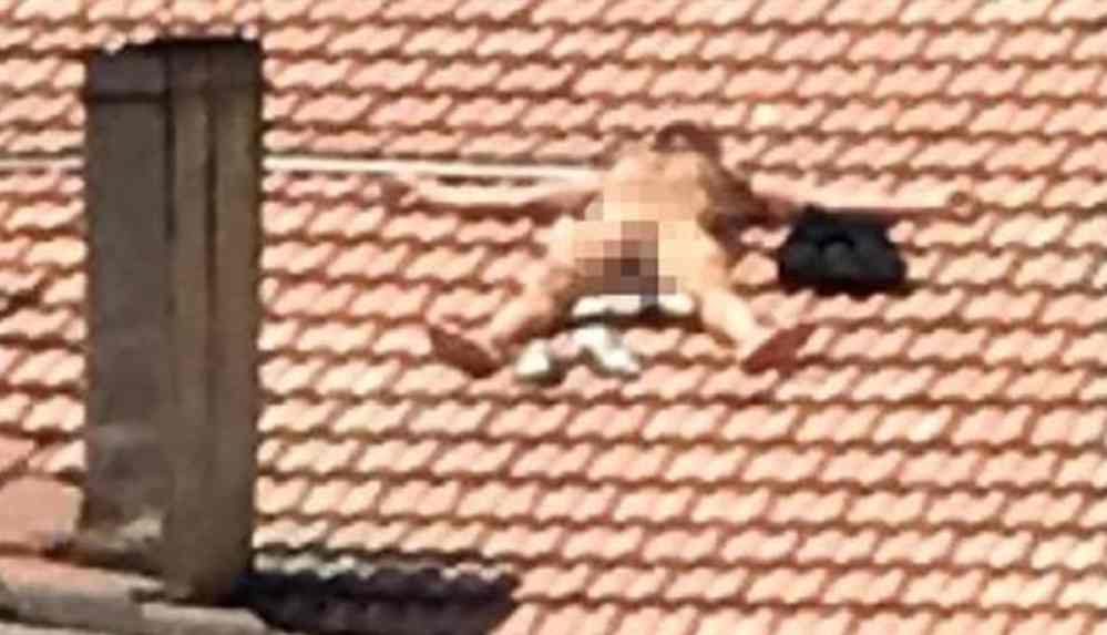 Çatıda çıplak güneşlendi, polisleri görünce saklandı